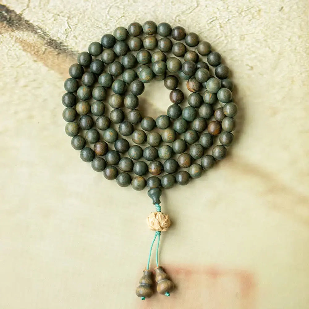 BWOOOH 108 mala beads bracelet crafted from natural green sandalwood and boxwood, featuring a distinct lotus symbol charm, designed for meditation, positive energy, and spiritual tranquility. - View 9
