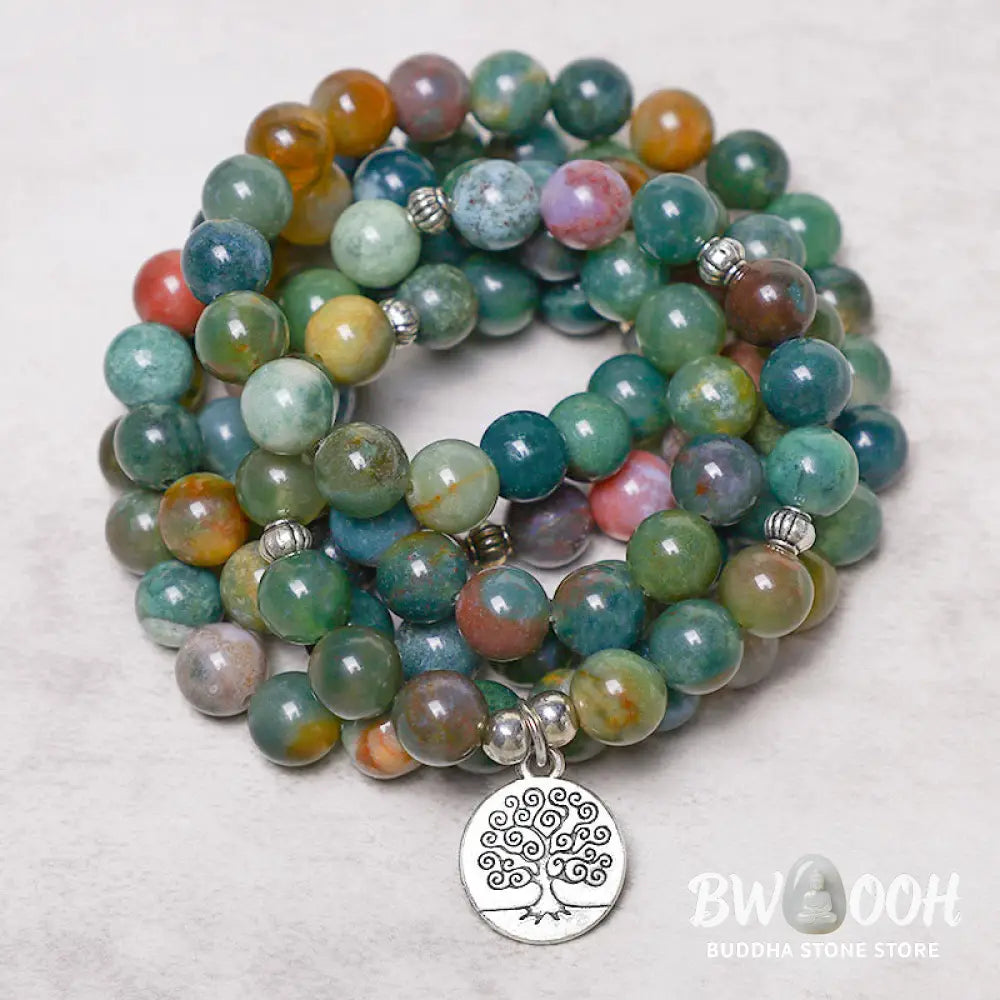 A BWOOOH 108 Indian Agate Mala Beads bracelet, featuring a prominent OM symbol charm, a serene Lotus charm, and a detailed Tree of Life charm, all strung on a premium elastic band, against a minimalist backdrop. - View 8