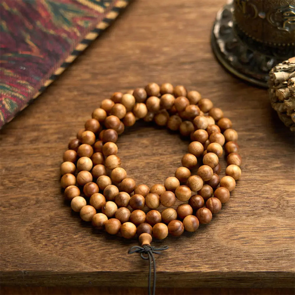 BWOOOH 108 Mala Beads, hand-polished Lightning Strike Peach Wood protection bracelet, 8mm beads on elastic string, worn by a unisex model, symbolizing divine energy and spiritual balance.