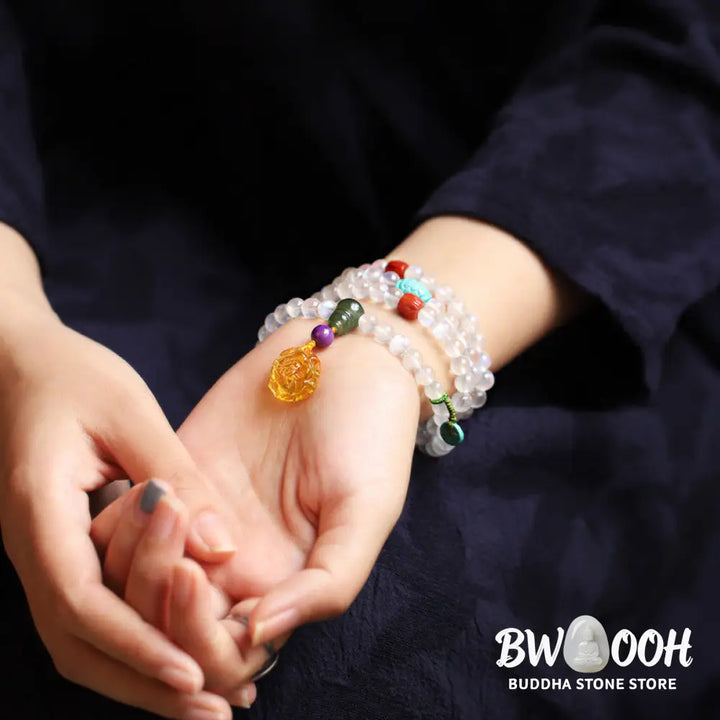 BWOOOH 108 Mala Beads bracelet handcrafted with shimmering Moonstone, warm Amber, vibrant Turquoise, and an engraved Lotus symbol, ideal for meditation and spiritual healing. - View 4