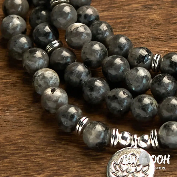 BWOOOH 108-bead multi-layer Black Glitter Stone Mala bracelet with engraved lotus pendant, symbolizing purity and strength, on a neutral background. - View 5