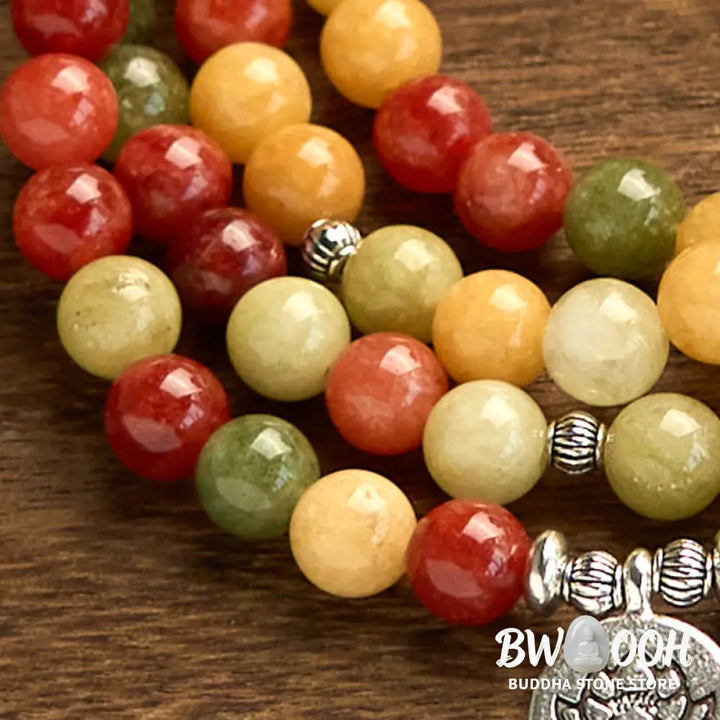 BWOOOH 108 Mala Beads bracelet, handcrafted with polished 8mm Topaz, Red Jasper, and Green Jasper stones on elastic string, featuring an engraved lotus pendant, shown on a neutral background, symbolizing protection and spiritual growth for mindfulness practices. - View 6