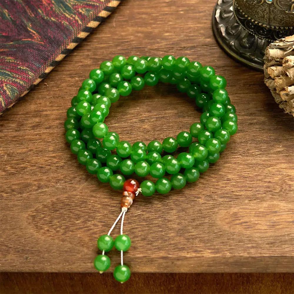 A BWOOOH 108-bead natural Cyan Jade mala bracelet, featuring smooth 8mm blue-green beads strung on premium elastic, ideal for meditation and daily wear.