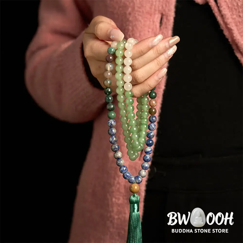 BWOOOH 108 Mala bracelet featuring 8mm natural Green Aventurine, Blue Spot Jasper, and Indian Agate beads with a vibrant green tassel, displayed on a meditation cushion, symbolizing luck, serenity, and balance for mindfulness practices. - View 3