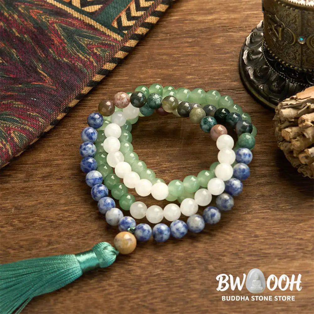 BWOOOH 108 Mala bracelet featuring 8mm natural Green Aventurine, Blue Spot Jasper, and Indian Agate beads with a vibrant green tassel, displayed on a meditation cushion, symbolizing luck, serenity, and balance for mindfulness practices. - View 7
