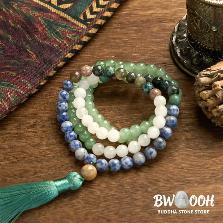 BWOOOH 108 Mala bracelet featuring 8mm natural Green Aventurine, Blue Spot Jasper, and Indian Agate beads with a vibrant green tassel, displayed on a meditation cushion, symbolizing luck, serenity, and balance for mindfulness practices. - View 7