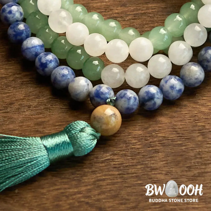 BWOOOH 108 Mala bracelet featuring 8mm natural Green Aventurine, Blue Spot Jasper, and Indian Agate beads with a vibrant green tassel, displayed on a meditation cushion, symbolizing luck, serenity, and balance for mindfulness practices. - View 9