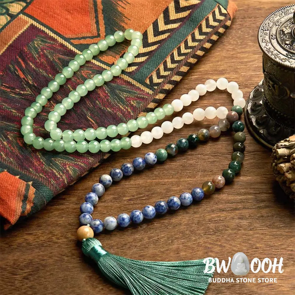 BWOOOH 108 Mala bracelet featuring 8mm natural Green Aventurine, Blue Spot Jasper, and Indian Agate beads with a vibrant green tassel, displayed on a meditation cushion, symbolizing luck, serenity, and balance for mindfulness practices. - View 2