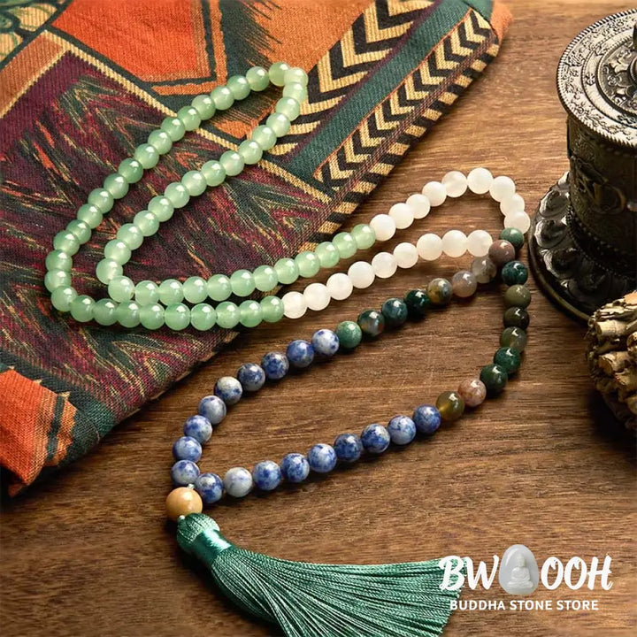 BWOOOH 108 Mala bracelet featuring 8mm natural Green Aventurine, Blue Spot Jasper, and Indian Agate beads with a vibrant green tassel, displayed on a meditation cushion, symbolizing luck, serenity, and balance for mindfulness practices. - View 2