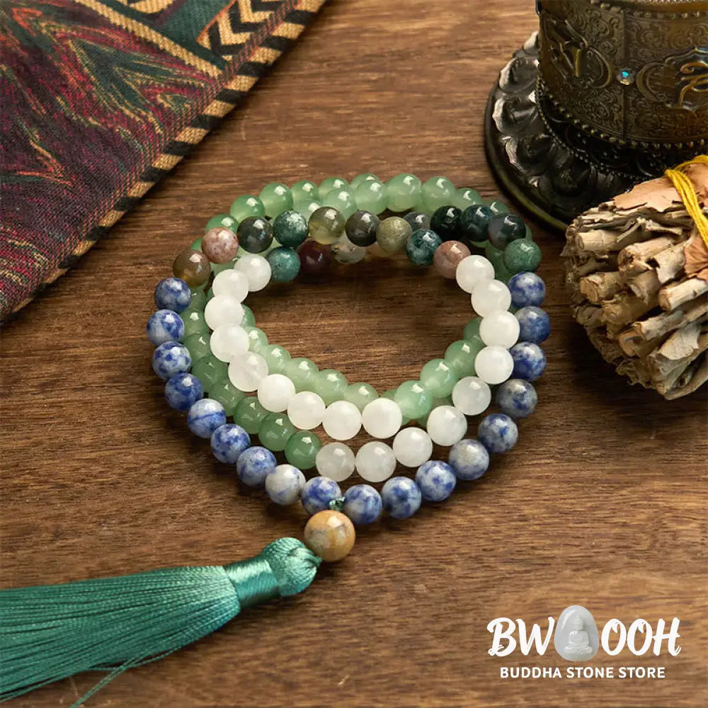 BWOOOH 108 Mala bracelet featuring 8mm natural Green Aventurine, Blue Spot Jasper, and Indian Agate beads with a vibrant green tassel, displayed on a meditation cushion, symbolizing luck, serenity, and balance for mindfulness practices. - View 6