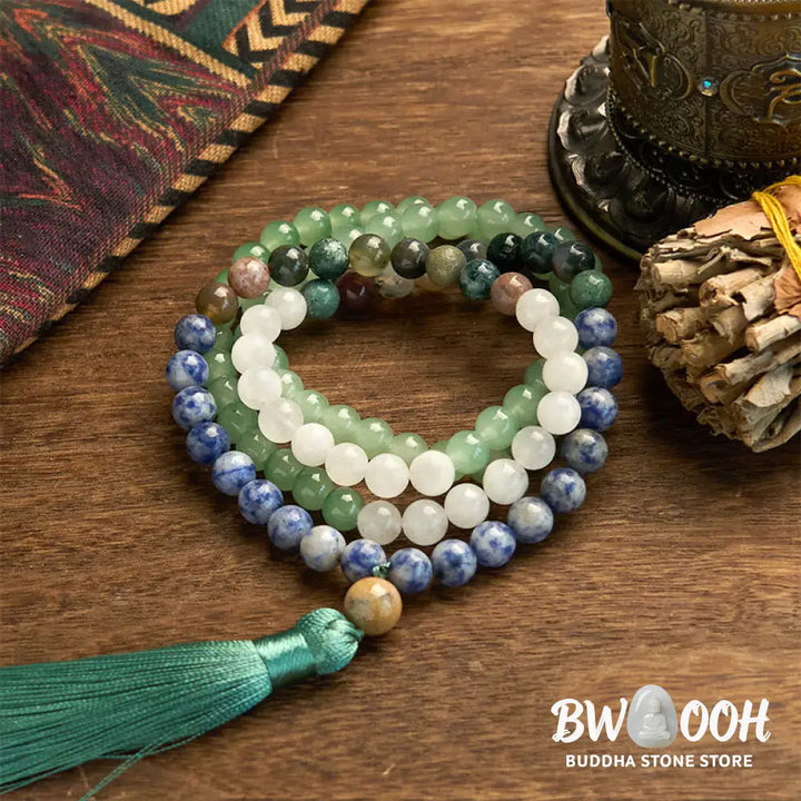 BWOOOH 108 Mala bracelet featuring 8mm natural Green Aventurine, Blue Spot Jasper, and Indian Agate beads with a vibrant green tassel, displayed on a meditation cushion, symbolizing luck, serenity, and balance for mindfulness practices. - View 6
