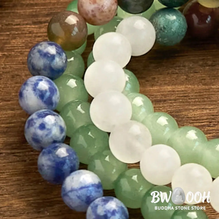 BWOOOH 108 Mala bracelet featuring 8mm natural Green Aventurine, Blue Spot Jasper, and Indian Agate beads with a vibrant green tassel, displayed on a meditation cushion, symbolizing luck, serenity, and balance for mindfulness practices. - View 8