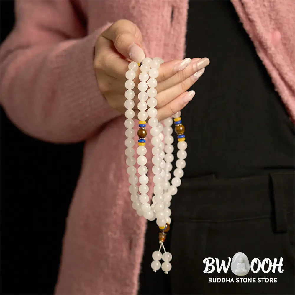 A close-up of the BWOOOH 108 Mala Beads Natural Quartzite Wealth Luck Bracelet, featuring polished 8mm quartzite and tiger eye beads on an elastic string, subtly revealing variations in natural color, embodying spiritual balance and prosperity. - View 7