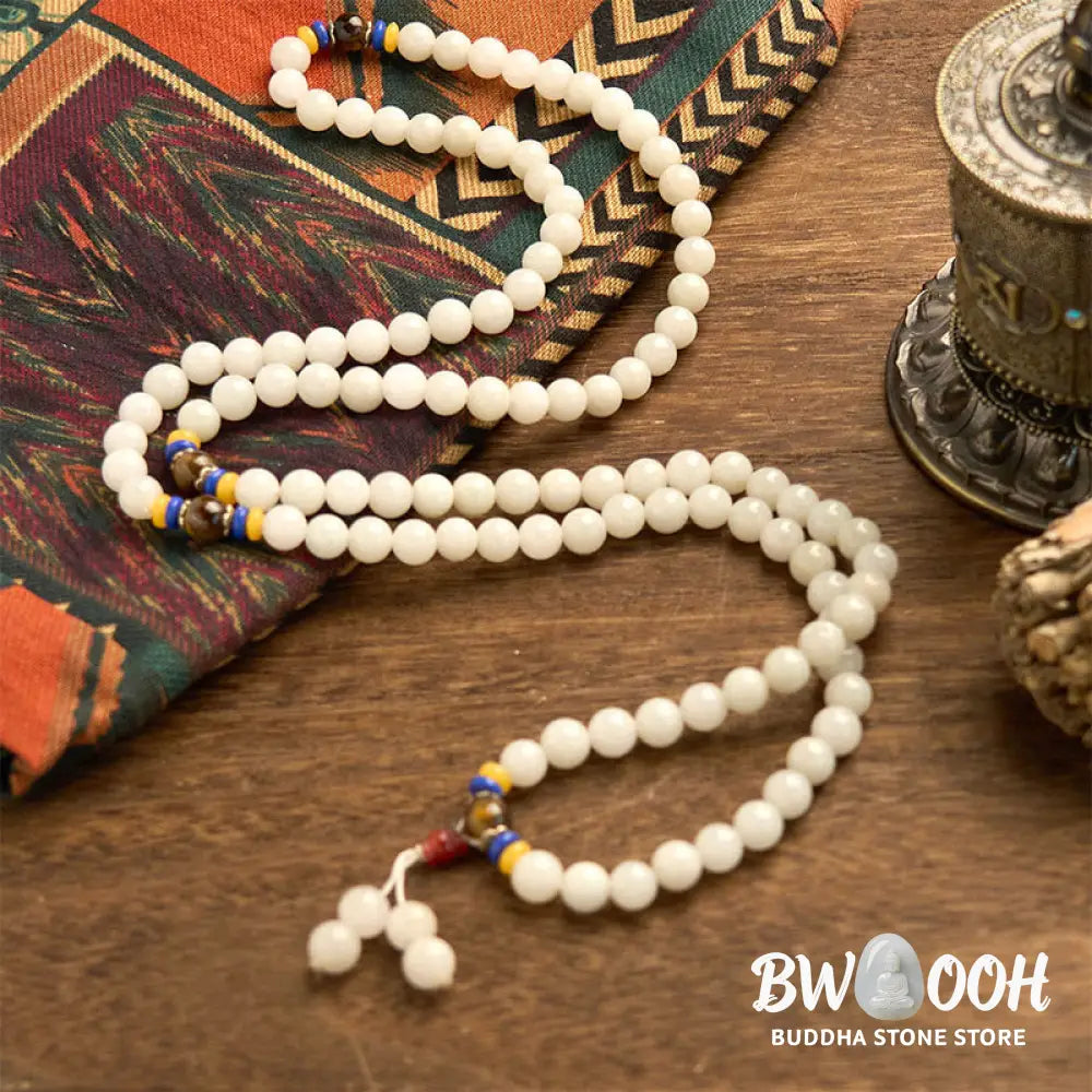 A close-up of the BWOOOH 108 Mala Beads Natural Quartzite Wealth Luck Bracelet, featuring polished 8mm quartzite and tiger eye beads on an elastic string, subtly revealing variations in natural color, embodying spiritual balance and prosperity. - View 9