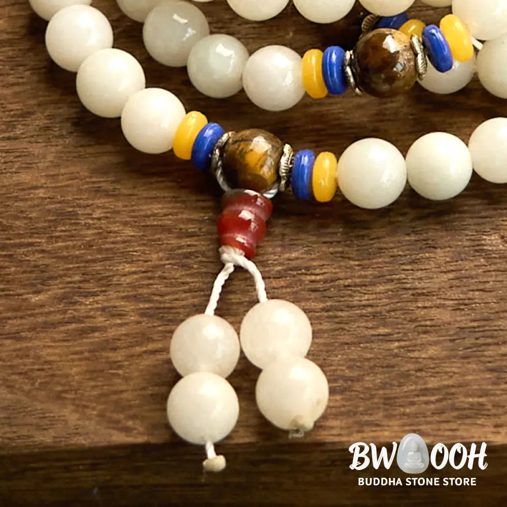 A close-up of the BWOOOH 108 Mala Beads Natural Quartzite Wealth Luck Bracelet, featuring polished 8mm quartzite and tiger eye beads on an elastic string, subtly revealing variations in natural color, embodying spiritual balance and prosperity. - View 15
