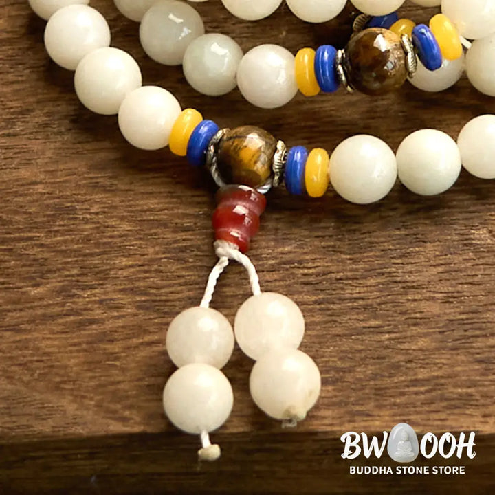 A close-up of the BWOOOH 108 Mala Beads Natural Quartzite Wealth Luck Bracelet, featuring polished 8mm quartzite and tiger eye beads on an elastic string, subtly revealing variations in natural color, embodying spiritual balance and prosperity. - View 15