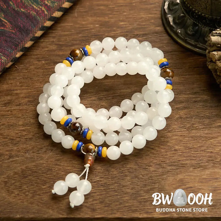 A close-up of the BWOOOH 108 Mala Beads Natural Quartzite Wealth Luck Bracelet, featuring polished 8mm quartzite and tiger eye beads on an elastic string, subtly revealing variations in natural color, embodying spiritual balance and prosperity. - View 11