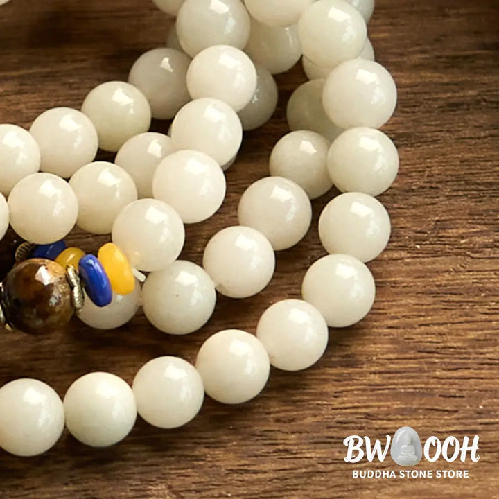 A close-up of the BWOOOH 108 Mala Beads Natural Quartzite Wealth Luck Bracelet, featuring polished 8mm quartzite and tiger eye beads on an elastic string, subtly revealing variations in natural color, embodying spiritual balance and prosperity. - View 12