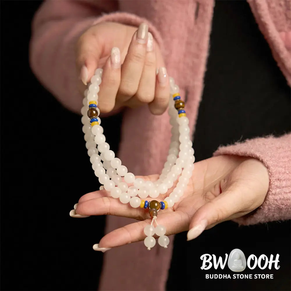 A close-up of the BWOOOH 108 Mala Beads Natural Quartzite Wealth Luck Bracelet, featuring polished 8mm quartzite and tiger eye beads on an elastic string, subtly revealing variations in natural color, embodying spiritual balance and prosperity. - View 6