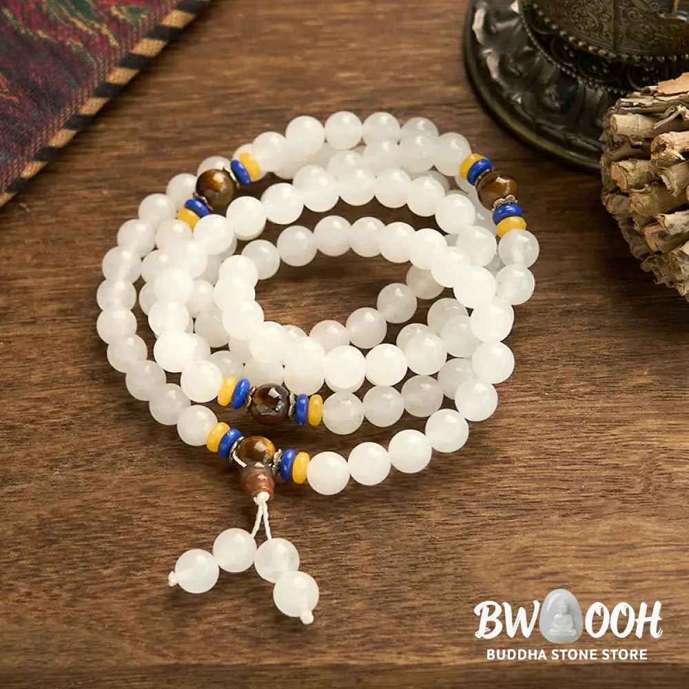 A close-up of the BWOOOH 108 Mala Beads Natural Quartzite Wealth Luck Bracelet, featuring polished 8mm quartzite and tiger eye beads on an elastic string, subtly revealing variations in natural color, embodying spiritual balance and prosperity. - View 5