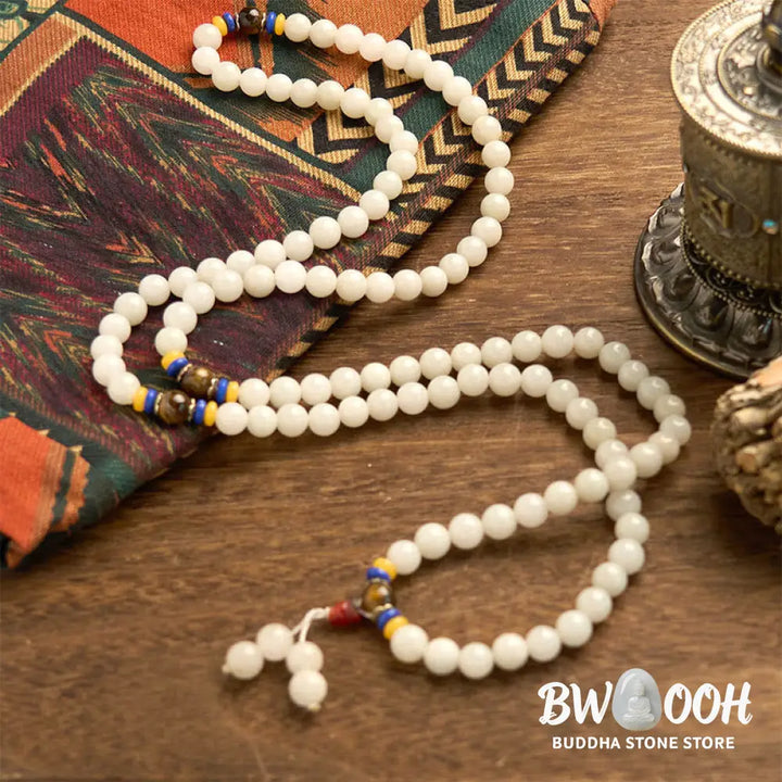 A close-up of the BWOOOH 108 Mala Beads Natural Quartzite Wealth Luck Bracelet, featuring polished 8mm quartzite and tiger eye beads on an elastic string, subtly revealing variations in natural color, embodying spiritual balance and prosperity. - View 10