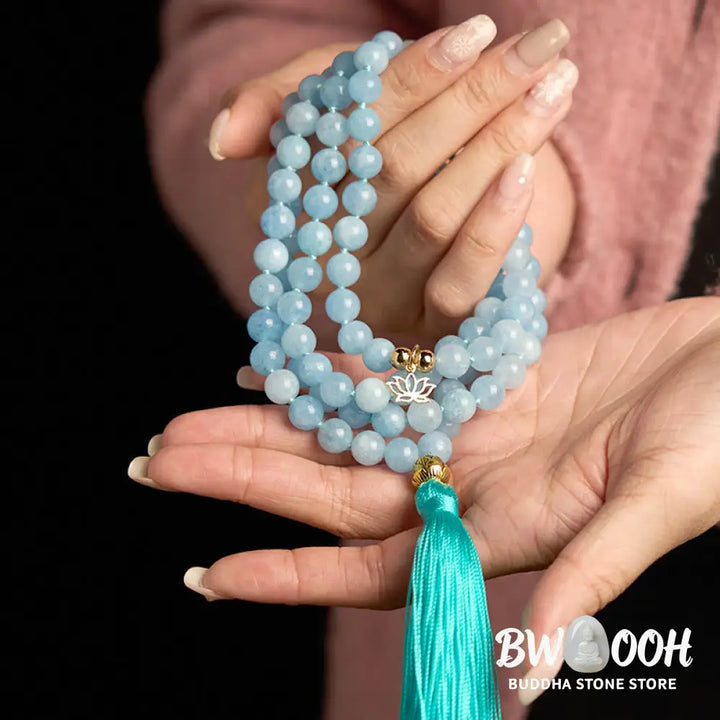 BWOOOH 108 Aquamarine Mala meditation bracelet featuring 8mm natural aquamarine beads and a delicate hollow lotus pendant, designed for spiritual healing and inner peace. Unisex, elastic string fit. - View 5