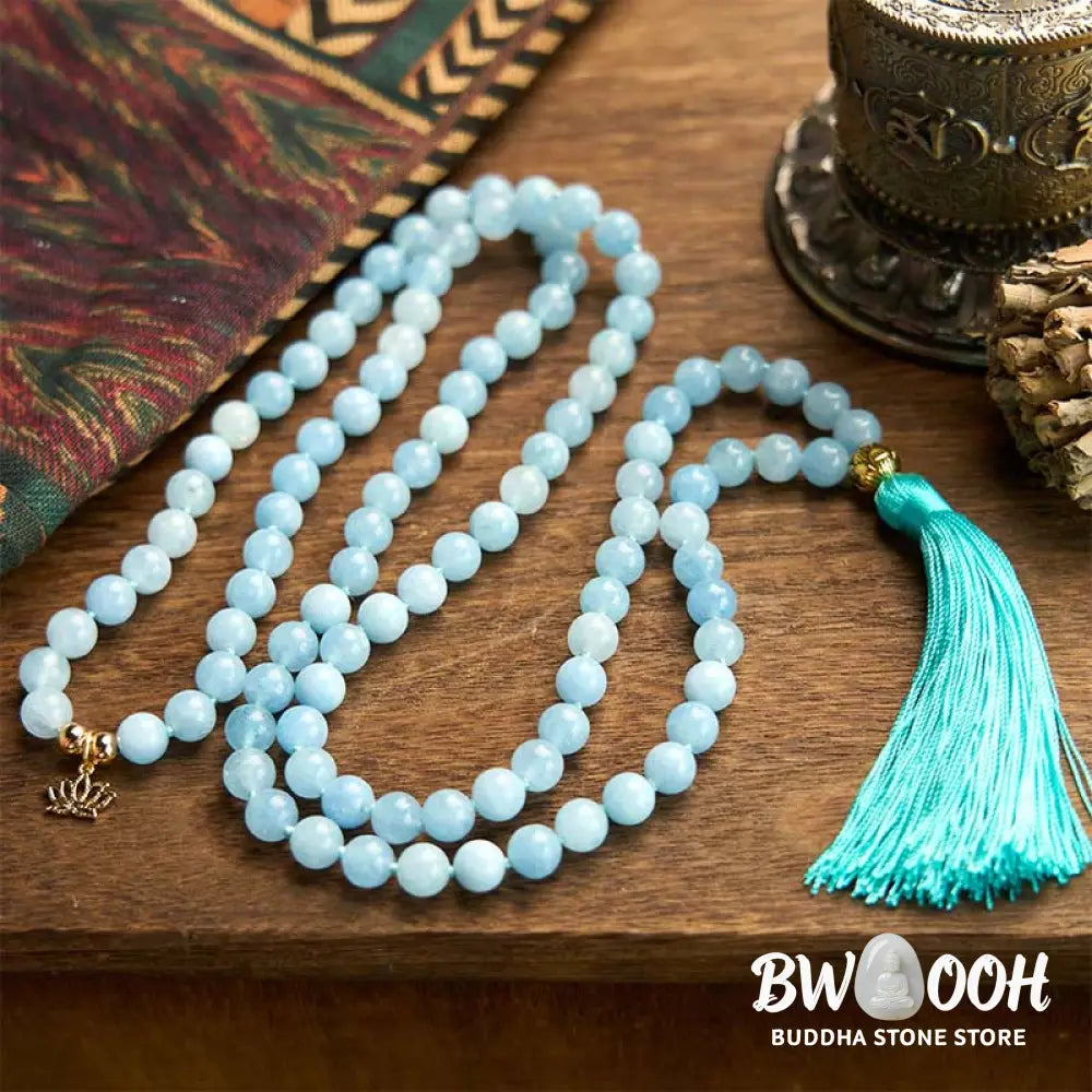 BWOOOH 108 Aquamarine Mala meditation bracelet featuring 8mm natural aquamarine beads and a delicate hollow lotus pendant, designed for spiritual healing and inner peace. Unisex, elastic string fit. - View 3