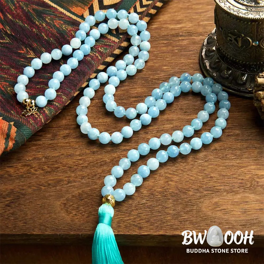BWOOOH 108 Aquamarine Mala meditation bracelet featuring 8mm natural aquamarine beads and a delicate hollow lotus pendant, designed for spiritual healing and inner peace. Unisex, elastic string fit. - View 2