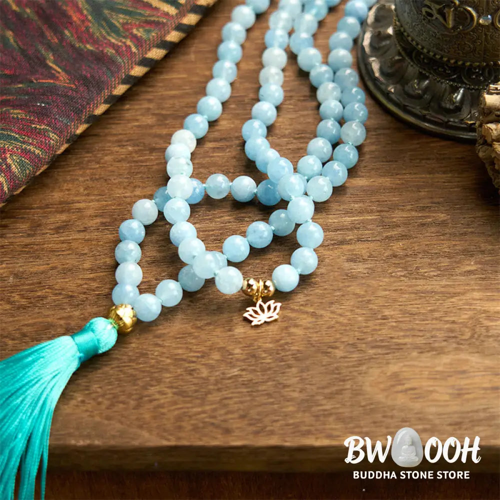 BWOOOH 108 Aquamarine Mala meditation bracelet featuring 8mm natural aquamarine beads and a delicate hollow lotus pendant, designed for spiritual healing and inner peace. Unisex, elastic string fit. - View 7