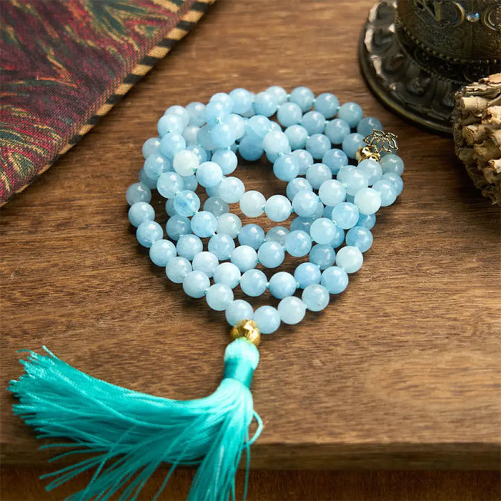 BWOOOH 108 Aquamarine Mala meditation bracelet featuring 8mm natural aquamarine beads and a delicate hollow lotus pendant, designed for spiritual healing and inner peace. Unisex, elastic string fit.