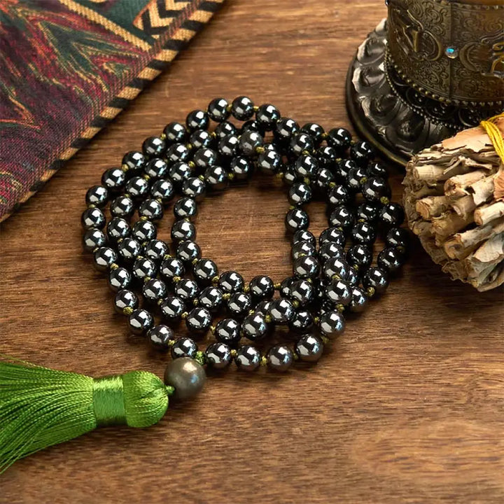 BWOOOH 108 Mala Beads natural hematite powerful bracelet with vibrant green tassel, symbolizing grounding and renewal for meditation and focus.