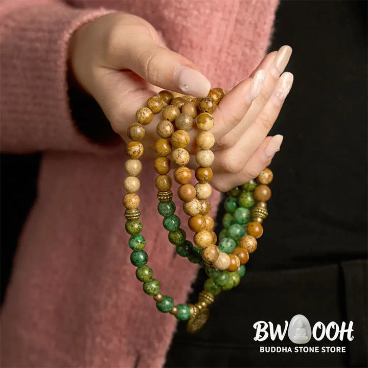 BWOOOH 108 Mala bracelet featuring earth-toned Picture Jasper and vibrant Turquoise 8mm beads, meticulously strung on premium elastic, with a prominent round silver lotus pendant symbolizing purity and growth. Ideal for mindful reflection. - View 4