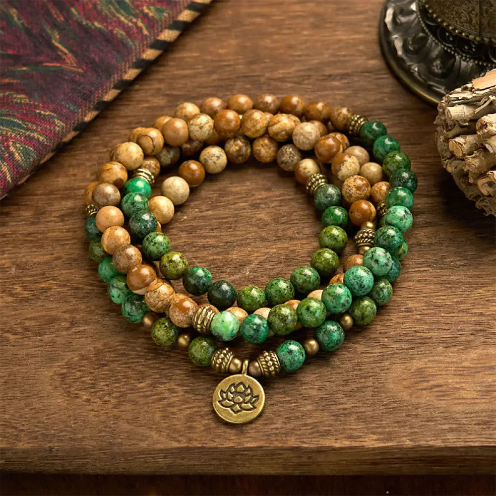 BWOOOH 108 Mala bracelet featuring earth-toned Picture Jasper and vibrant Turquoise 8mm beads, meticulously strung on premium elastic, with a prominent round silver lotus pendant symbolizing purity and growth. Ideal for mindful reflection.