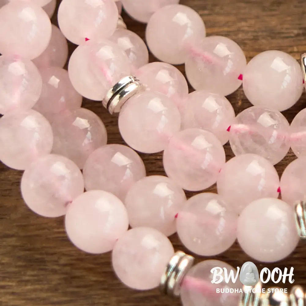 A BWOOOH Rose Quartz 108 mala bead bracelet with 8mm natural stones, featuring a round engraved lotus peace symbol pendant on a premium elastic string, ideal for meditation and emotional balance. - View 6