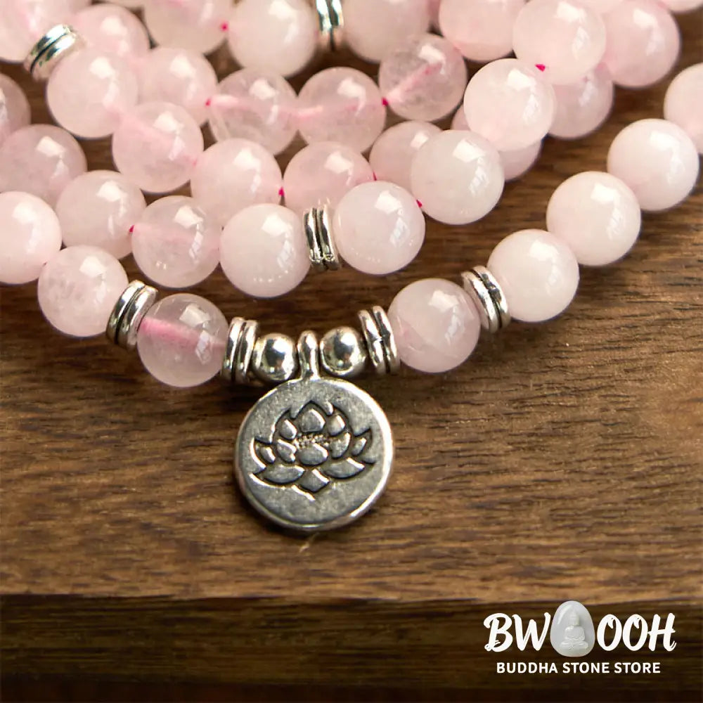 A BWOOOH Rose Quartz 108 mala bead bracelet with 8mm natural stones, featuring a round engraved lotus peace symbol pendant on a premium elastic string, ideal for meditation and emotional balance. - View 7