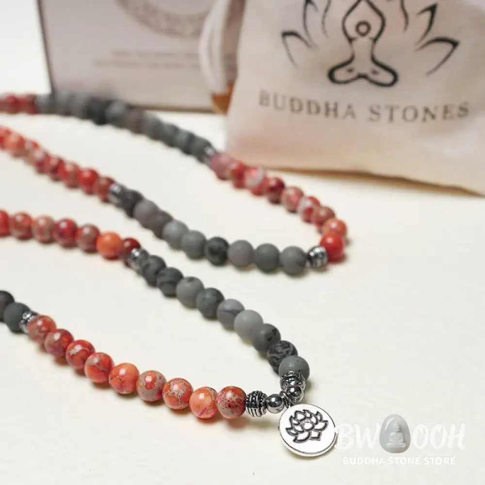 BWOOOH 108-bead Sea Sediment Jasper Lotus Protection Bracelet, displaying natural blue-green and orange Jasper beads with a silver-tone lotus charm, laid against a neutral background. - View 6