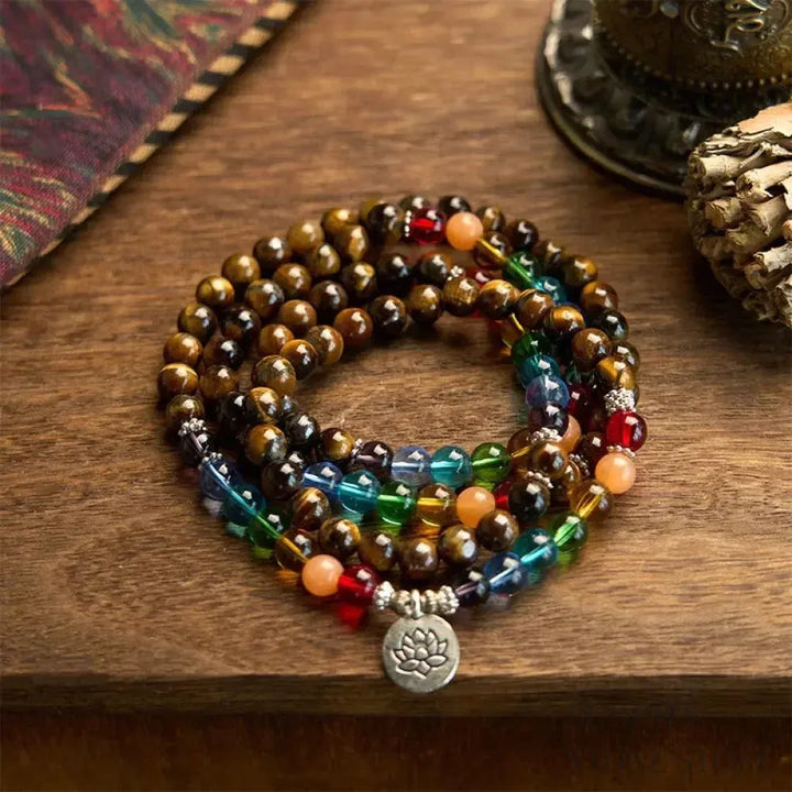 BWOOOH 108 Mala Beads bracelet featuring 8mm natural Tiger Eye and colorful glass beads on an elastic string, adorned with an engraved lotus pendant, symbolizing purity and protection. Unisex design for spiritual practice.