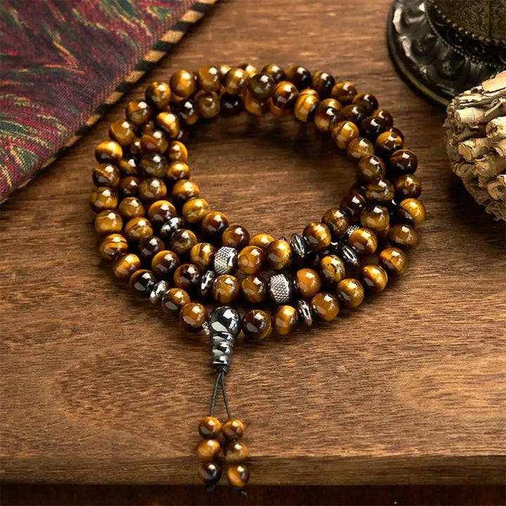 BWOOOH 108 Mala Beads multi-turn bracelet featuring polished 8mm natural Tiger Eye stones and stainless steel accents, worn on a wrist for spiritual protection and mindful meditation.