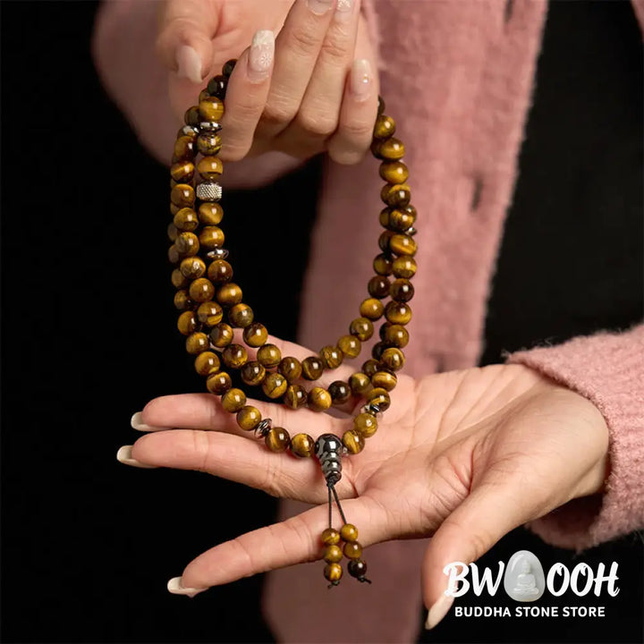 BWOOOH 108 Mala Beads multi-turn bracelet featuring polished 8mm natural Tiger Eye stones and stainless steel accents, worn on a wrist for spiritual protection and mindful meditation. - View 4
