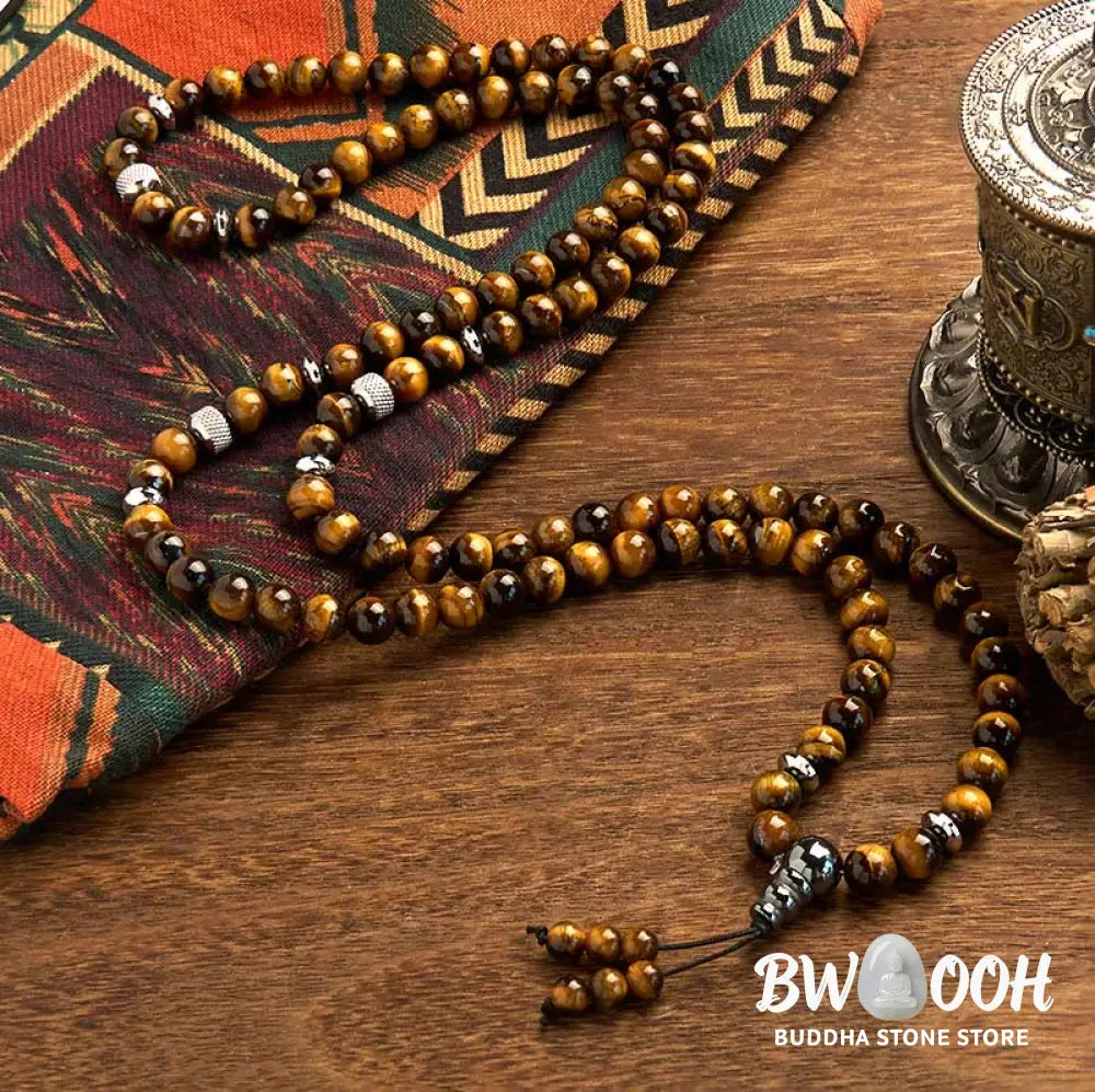 BWOOOH 108 Mala Beads multi-turn bracelet featuring polished 8mm natural Tiger Eye stones and stainless steel accents, worn on a wrist for spiritual protection and mindful meditation. - View 2