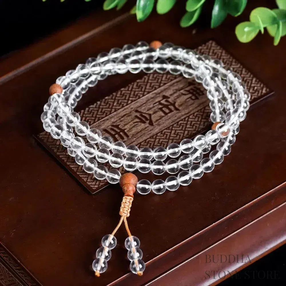 BWOOOH 108 Mala Beads, a unisex meditation bracelet featuring 6mm natural white crystal and distinct sandalwood beads, elegantly wrapped on a premium elastic string.