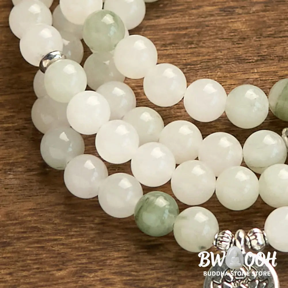 BWOOOH 108-bead Tianshan Jade Mala bracelet, handcrafted with 8mm calming green jade beads and an engraved silver-tone lotus charm on a premium elastic string, photographed against a minimalist backdrop, highlighting its spiritual elegance and detailed craftsmanship for meditation and mindful wear. - View 7