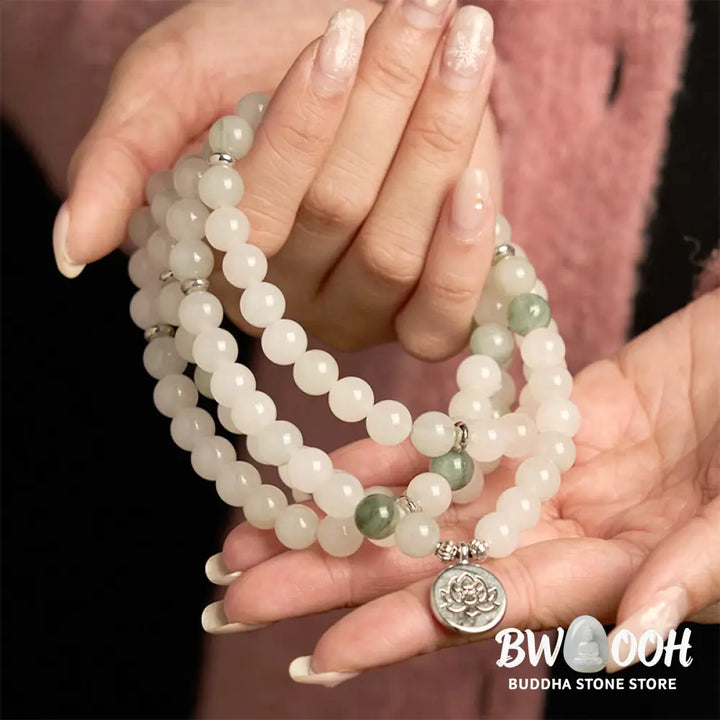 BWOOOH 108-bead Tianshan Jade Mala bracelet, handcrafted with 8mm calming green jade beads and an engraved silver-tone lotus charm on a premium elastic string, photographed against a minimalist backdrop, highlighting its spiritual elegance and detailed craftsmanship for meditation and mindful wear. - View 4