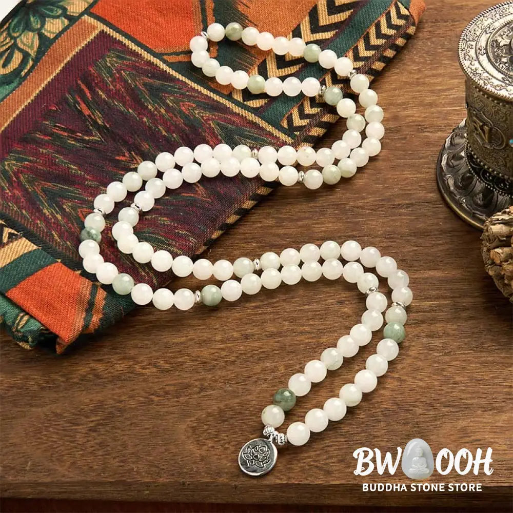 BWOOOH 108-bead Tianshan Jade Mala bracelet, handcrafted with 8mm calming green jade beads and an engraved silver-tone lotus charm on a premium elastic string, photographed against a minimalist backdrop, highlighting its spiritual elegance and detailed craftsmanship for meditation and mindful wear. - View 2