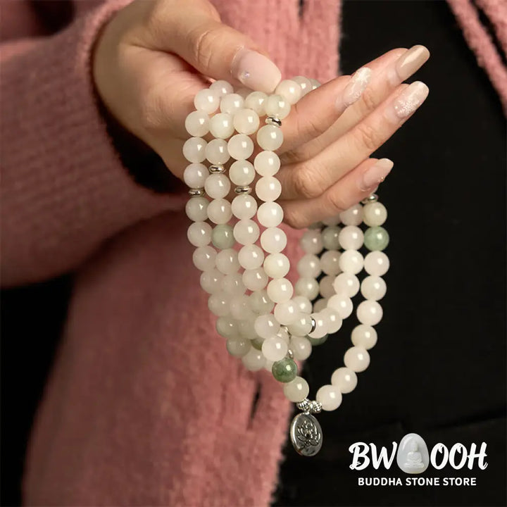 BWOOOH 108-bead Tianshan Jade Mala bracelet, handcrafted with 8mm calming green jade beads and an engraved silver-tone lotus charm on a premium elastic string, photographed against a minimalist backdrop, highlighting its spiritual elegance and detailed craftsmanship for meditation and mindful wear. - View 3