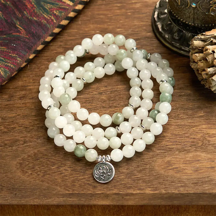 BWOOOH 108-bead Tianshan Jade Mala bracelet, handcrafted with 8mm calming green jade beads and an engraved silver-tone lotus charm on a premium elastic string, photographed against a minimalist backdrop, highlighting its spiritual elegance and detailed craftsmanship for meditation and mindful wear.
