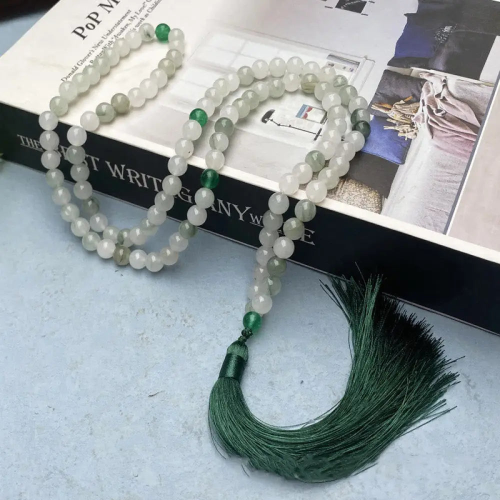 BWOOOH 108 Mala Beads Bracelet featuring polished natural Tianshan Jade, accented with a vibrant tassel. This exquisite meditation and luck accessory showcases the unique jade stone, interwoven with South Red Agate and Green Agate, designed for spiritual balance and attracting prosperity.