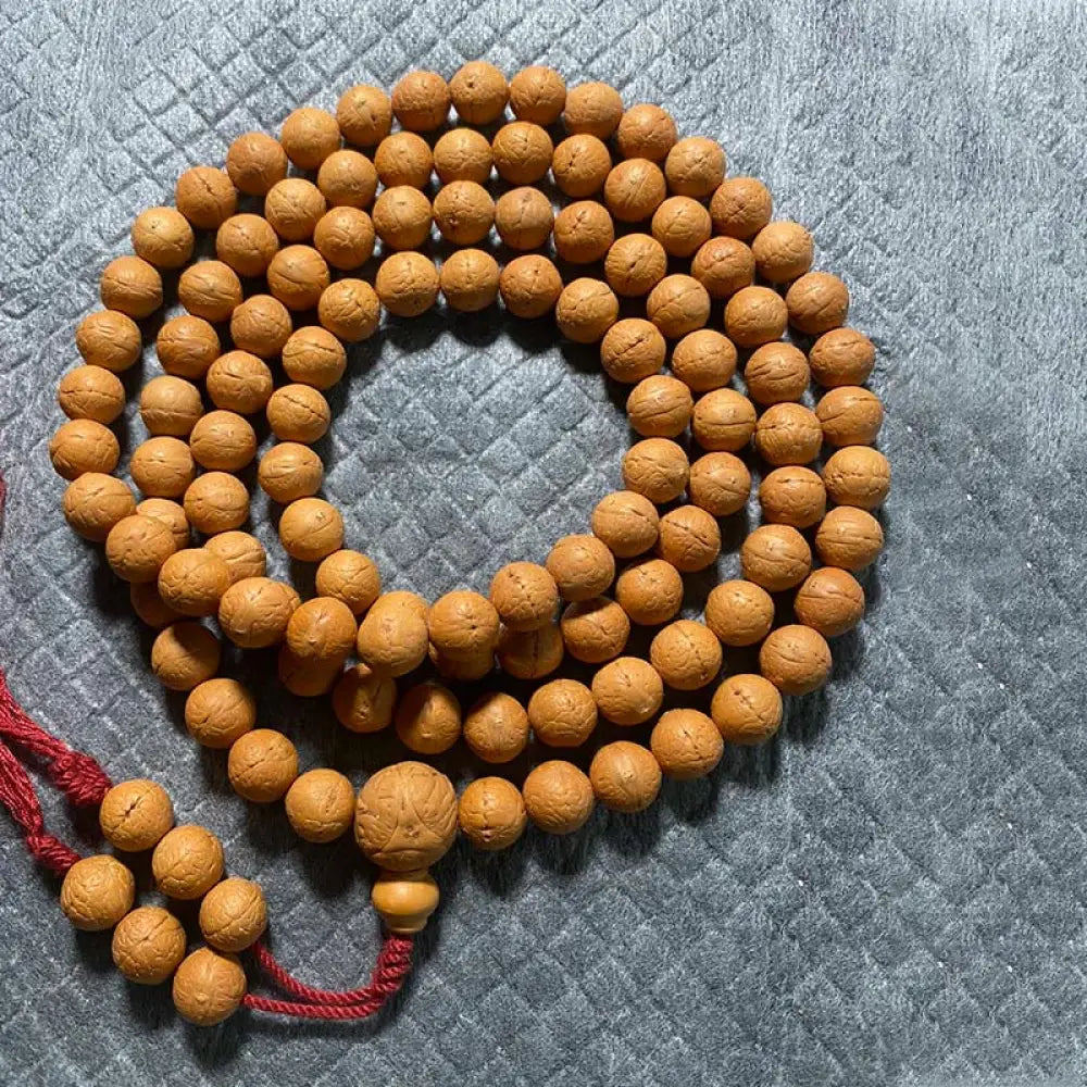 BWOOOH 108-bead Nepal Bodhi Seed Mala bracelet featuring varied 11-13mm dark-speckled seeds on premium string, with a symbolic tassel, designed for meditation and daily spiritual awareness. - View 9