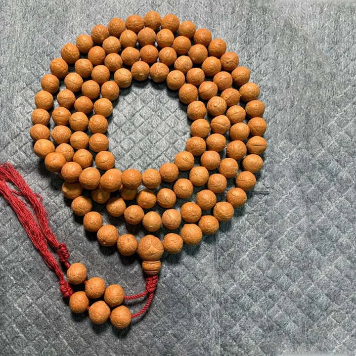 BWOOOH 108-bead Nepal Bodhi Seed Mala bracelet featuring varied 11-13mm dark-speckled seeds on premium string, with a symbolic tassel, designed for meditation and daily spiritual awareness. - View 6