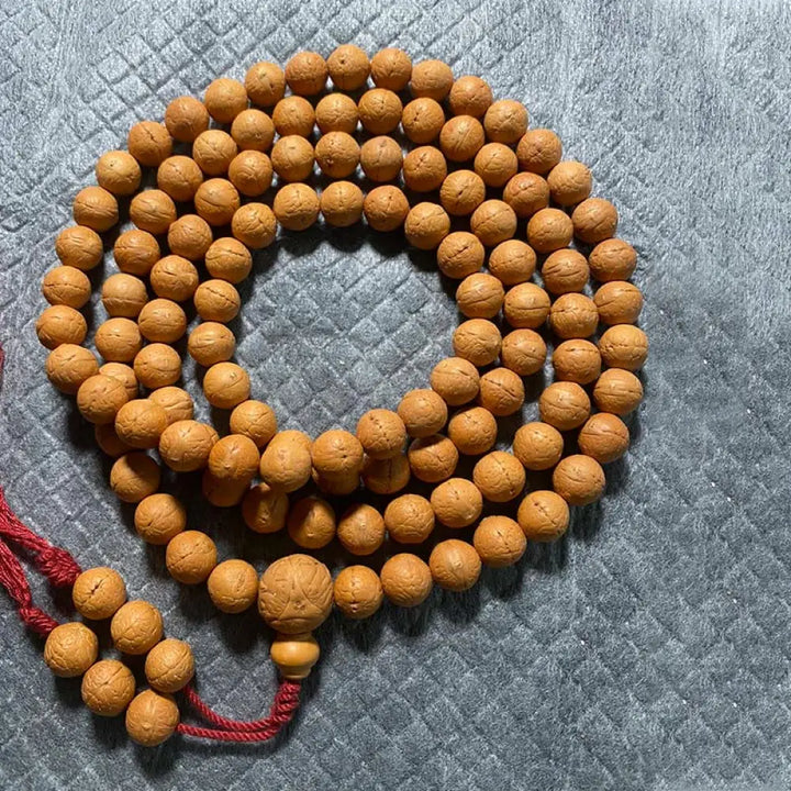 A BWOOOH 108-bead Nepal Bodhi Seed Mala bracelet, handcrafted with unique dark-speckled seeds on premium string, for meditation, enlightenment, and positive energy. - View 9